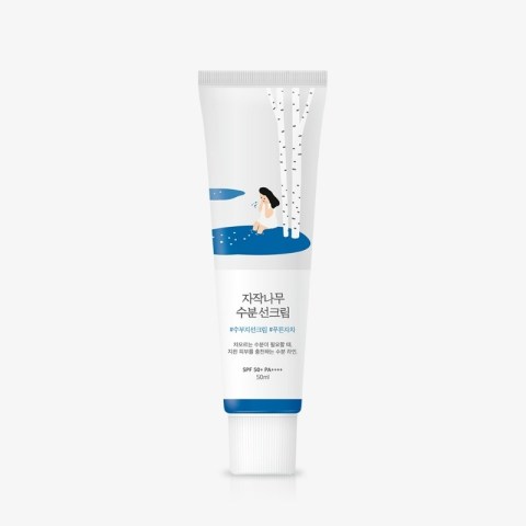 Sunscreen cream tube with Korean label and illustration of a woman by birch trees in a blue pond scene (SPF 50+ PA++++).