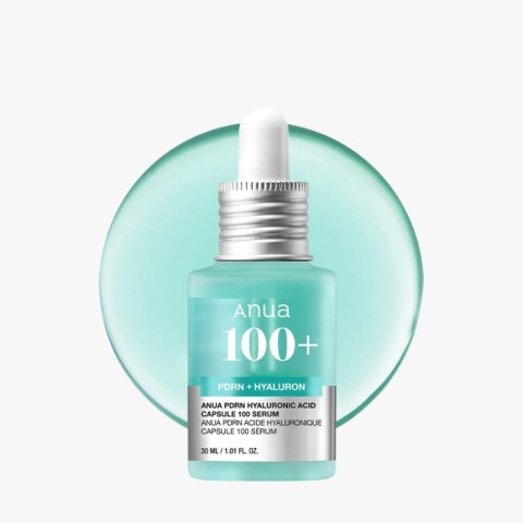 Teal glass dropper bottle labeled 'Anua 100+' with a silver cap, against a teal circular background.
