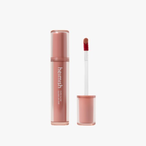 Rose-gold lip gloss tube with wand removed, pink gloss visible on the applicator, brand name heimish on the bottle.