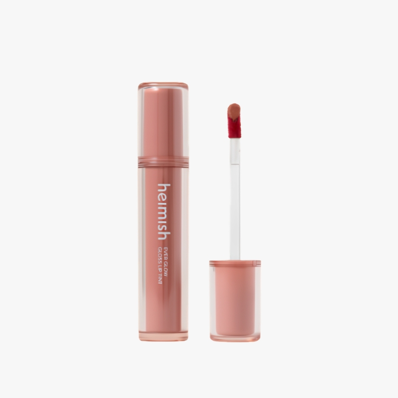Rose-gold lip gloss tube with wand removed, pink gloss visible on the applicator, brand name heimish on the bottle.