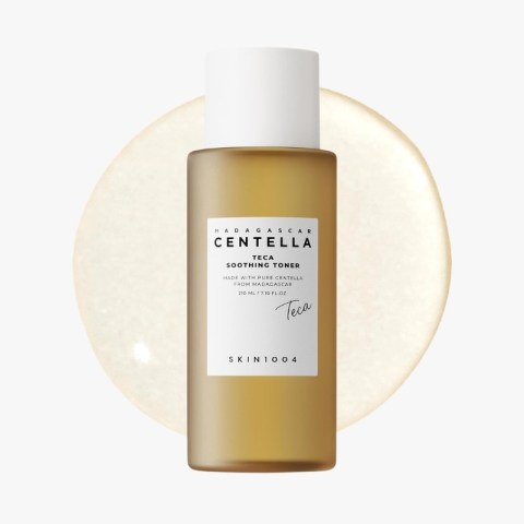 Brown glass bottle of Centella Teca Soothing Toner with a white label, centered in front of a pale beige circular backdrop.